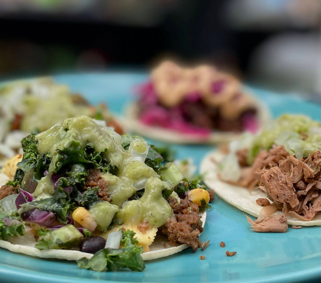 Assorted tacos on a blue plate