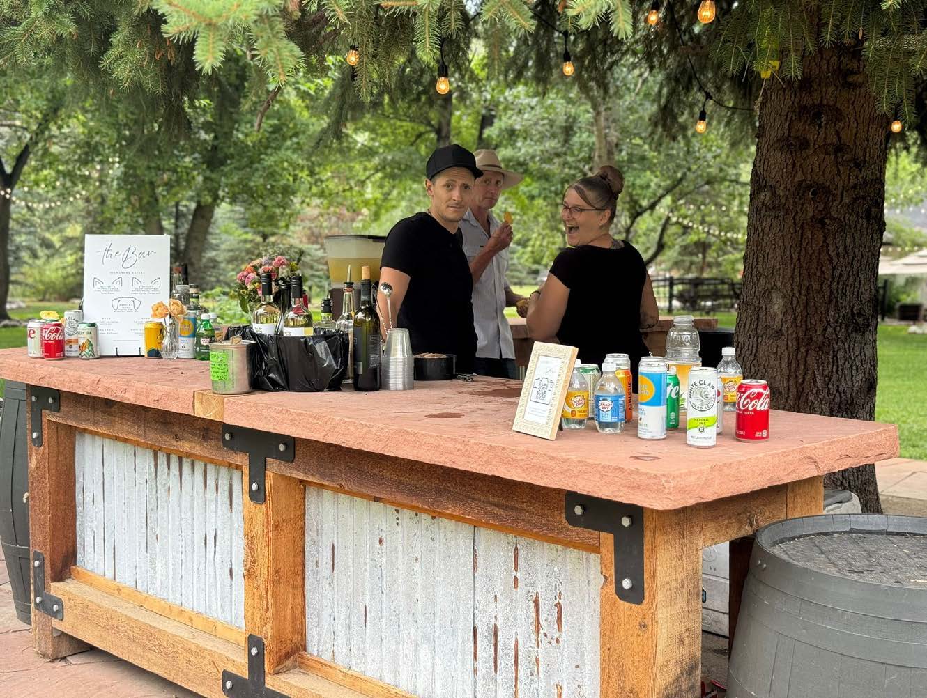 Outdoor bartending setup with guests